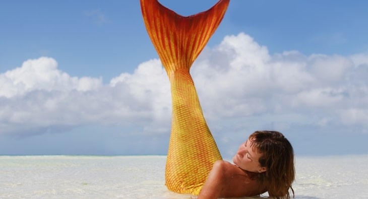 Mermaid lying on a beach