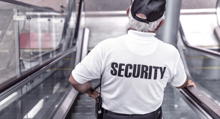 Security officer on escalator 